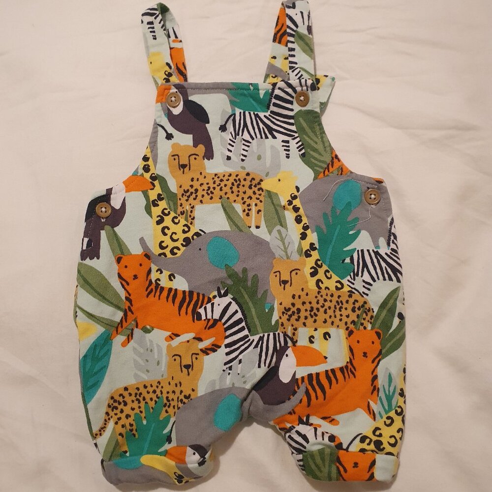 Jungle theme baby dungarees. 1 month.
